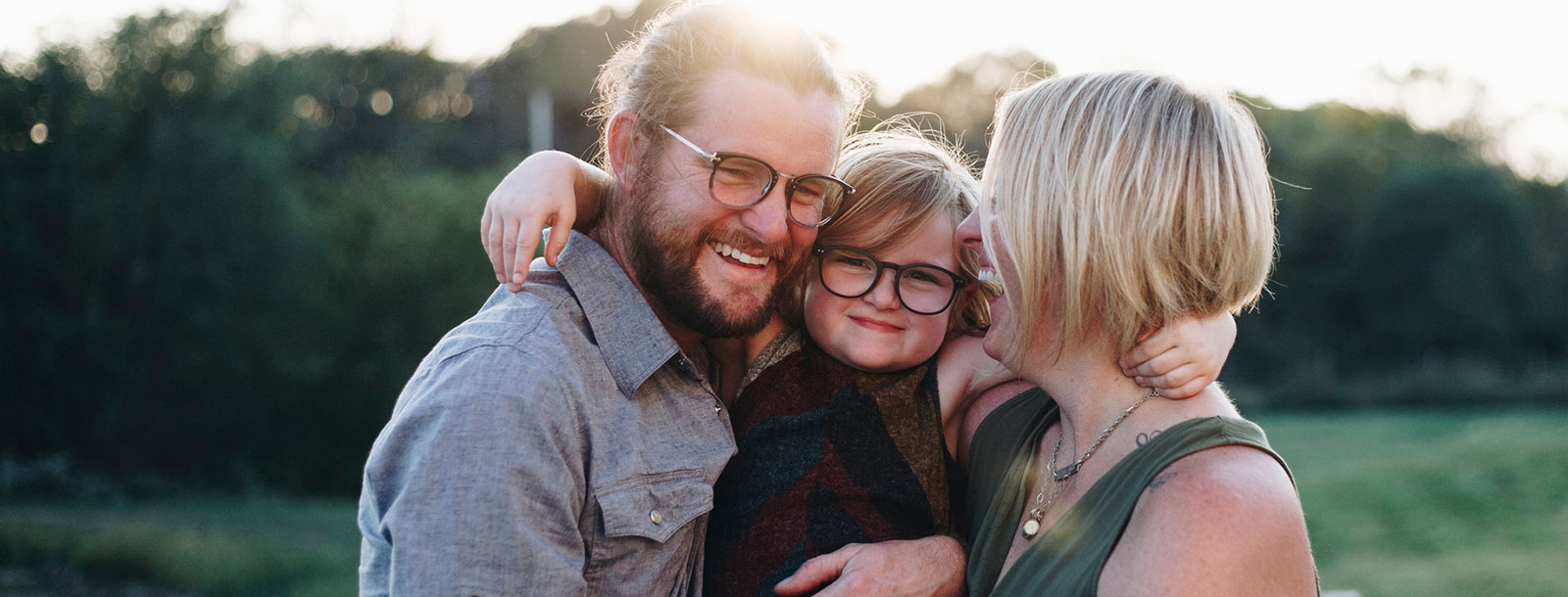 Young parents and child outdoors.