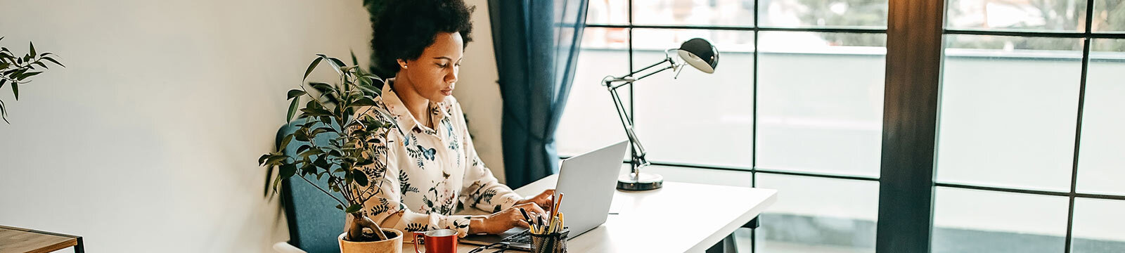 Woman on laptop in office.